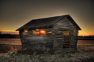 photo of brown and gray wooden house during sunset
