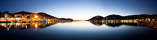 panorama photography of sea between the lighted houses HD wallpaper