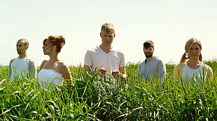group of person standing in green plants