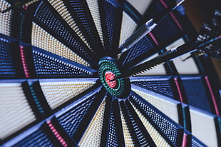 closeup photo of dart board with pins