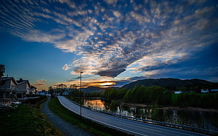photograph of gray concrete road during sunset