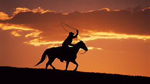 silhouette of a man riding horse