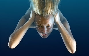 blonde-haired woman underwater