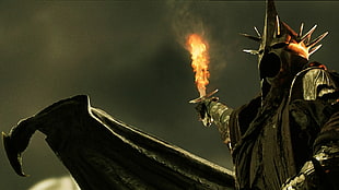 armored soldier holding flaming torch digital wallpaper