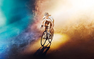 photo of woman in white riding road bike