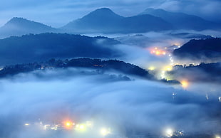 aerial photo of foggy city with lights