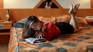 women's red long-sleeved shirt and black bottoms, women, skirt, in bed, feet in the air