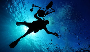 silhouette of person doing scuba diving