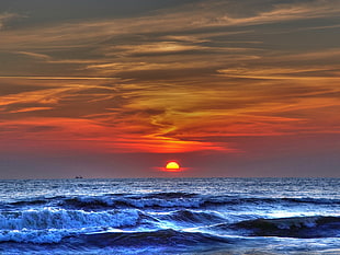 Sunset over horizon near beach HD wallpaper
