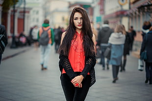woman in red sleeveless blouse and black bottoms