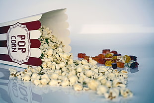 scattered popcorn and popcorn container