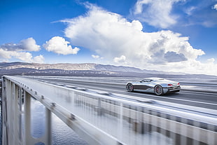 timelapse photography of sports car on the bridge under cloudy sky