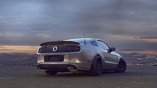 silver ford mustang gt on gray concrete pavement