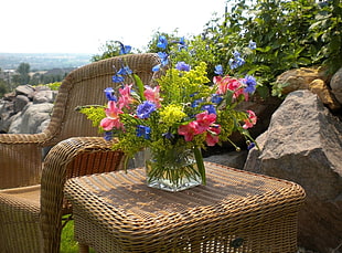pink and blue flower arrangement in glass vase