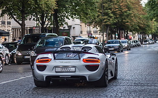 silver sports car in the middle of road during daytime HD wallpaper