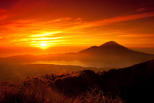 mountain surrounded by forest sunset photo