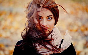 selective focus photography of woman wearing gray scarf