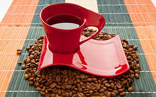 red coffee mug on saucer surrounded with coffee beans HD wallpaper