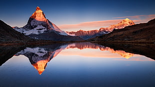 mountain near lake during golden hour