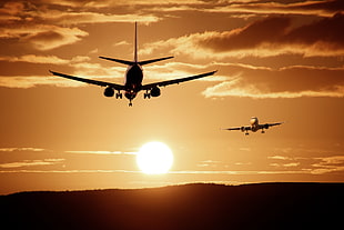 two commercial planes flying during golden hour HD wallpaper