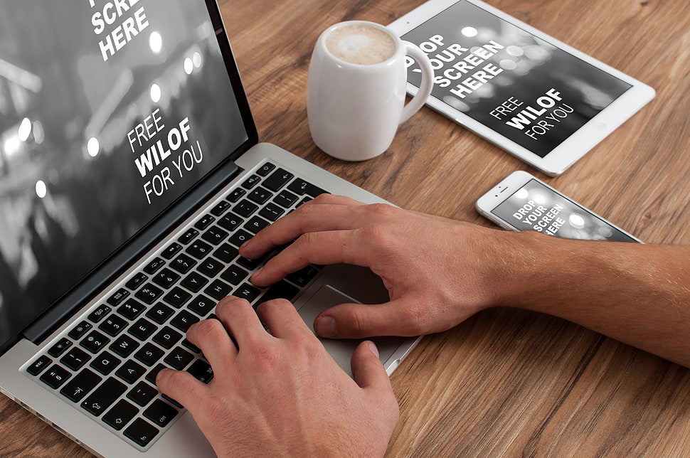 MacBook Pro near white ceramic mug HD wallpaper