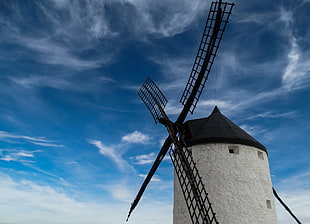 windmill under cloudy sky at daytime