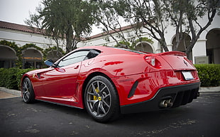 parked ahead red Ferrari 599 GTO near white house during daytime HD wallpaper