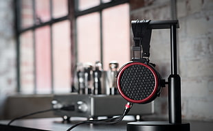 focus photo of black and red corded headphones
