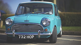 photo of teal Mini Cooper during daytime