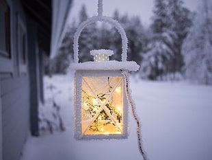 white and yellow lighted outdoor lantern during winter