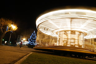 white and brown ceramic bowl, long exposure, carousel, lights, city