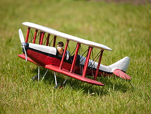 pilot in red and white bi-plane toy