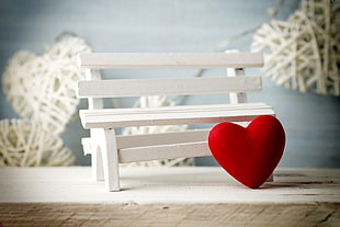 red heart decor beside white bench miniature photography