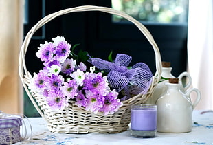 purple and white flower bouquet in basket
