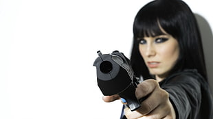 woman holding a black pistol