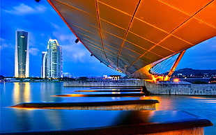 white concrete building near body of water HD wallpaper
