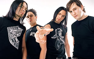 four men wearing black shirts