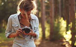 selective focus photography of woman with MILC camera