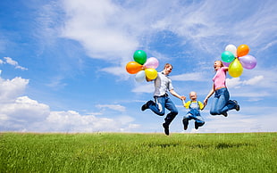 father, mother, and son jumping together HD wallpaper