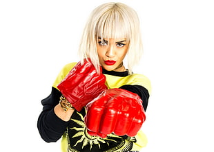 woman in yellow and black shirt wearing red boxing gloves