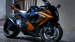 black and orange Suzuki sports bike, motorcycle
