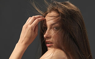 woman left hand near face with air blowing her hair HD wallpaper