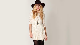 woman wearing white short-sleeved floral designed shirt with black hat and black bottoms photography