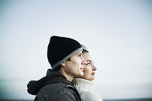 portrait photography of man and woman in white and black sweaters
