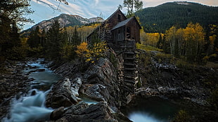 brown house on cliff near river