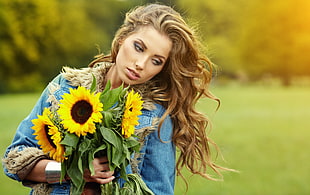 woman holding sunflower high saturated photography