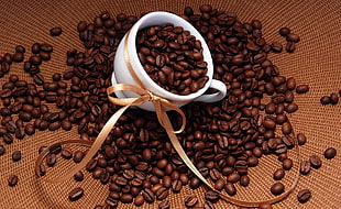 coffee beans with white ceramic teacup