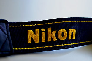 red and black Supreme knit cap, Nikon, logo