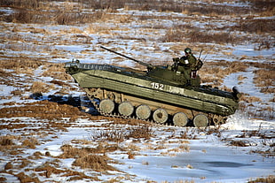 soldier riding battle tank