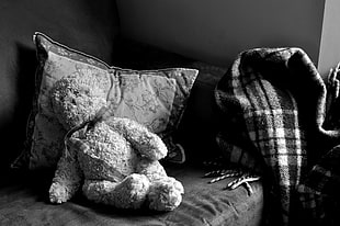 teddy bear plush toy in sofa chair